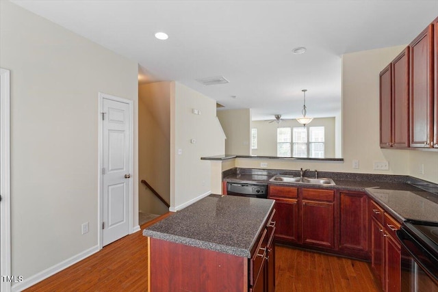 229 Michigan Ave, Cary, NC 27519 - kitchen with a sink, reddish brown cabinets, black appliances, dark wood finished floors, and a ceiling fan