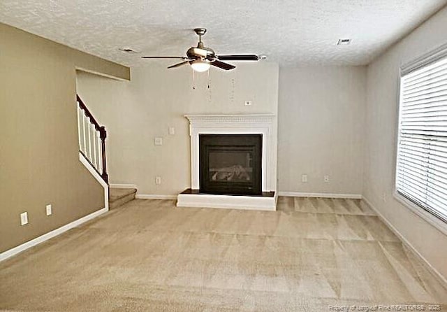 1824 Ponderosa Trl, Cameron, NC 28326 - unfurnished living room featuring ceiling fan, healthy amount of natural light, light carpet, and a textured ceiling