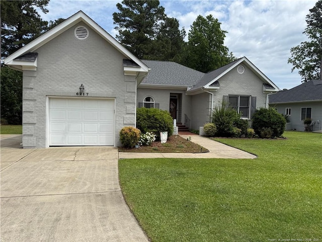 6217 Falkland Ct, Fayetteville, NC 28311 - view of front of house featuring concrete driveway, a front lawn, brick siding, and a garage