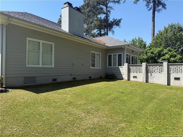 6217 Falkland Ct, Fayetteville, NC 28311 - rear view of property featuring crawl space, a chimney, and roof with shingles