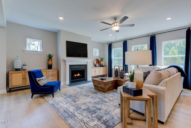 2512 Stonington Dr, Cary, NC 27523 - living area with light wood finished floors, a ceiling fan, a fireplace with flush hearth, recessed lighting, and baseboards