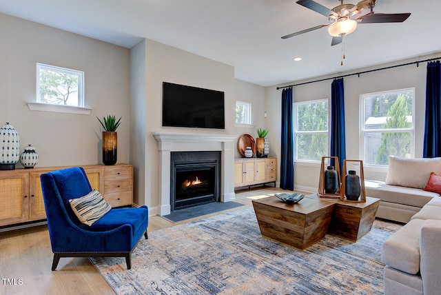 2512 Stonington Dr, Cary, NC 27523 - living area with wood finished floors, a fireplace with flush hearth, ceiling fan, recessed lighting, and baseboards