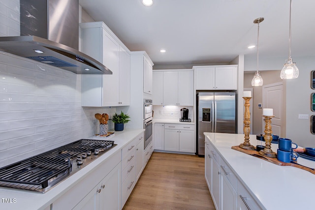 2512 Stonington Dr, Cary, NC 27523 - kitchen featuring wall chimney range hood, stainless steel appliances, white cabinetry, light countertops, and backsplash