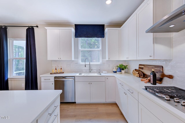 2512 Stonington Dr, Cary, NC 27523 - kitchen featuring appliances with stainless steel finishes, a sink, under cabinet range hood, plenty of natural light, and recessed lighting