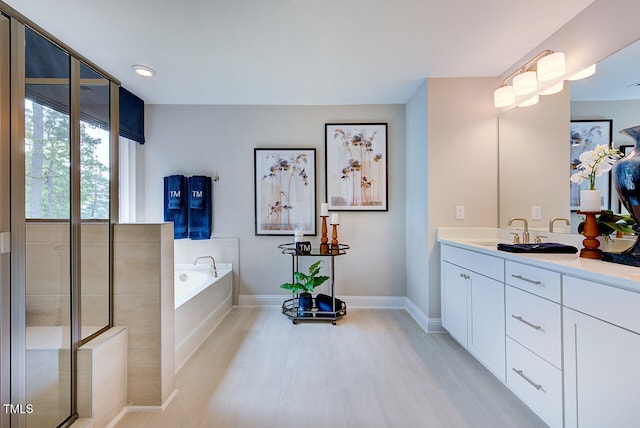 2512 Stonington Dr, Cary, NC 27523 - bathroom with baseboards, vanity, a garden tub, and recessed lighting