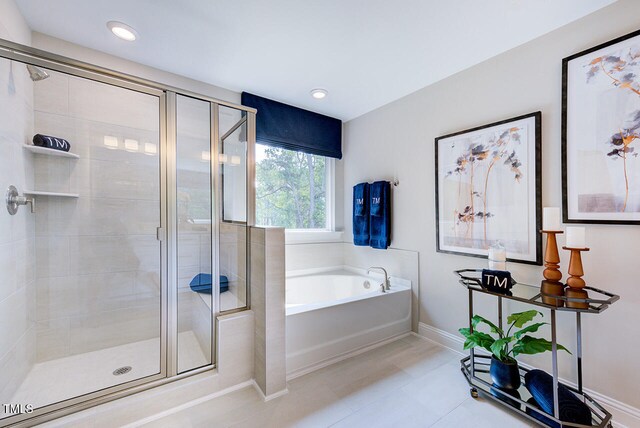 2512 Stonington Dr, Cary, NC 27523 - bathroom featuring a bath, a shower stall, baseboards, tile patterned floors, and recessed lighting