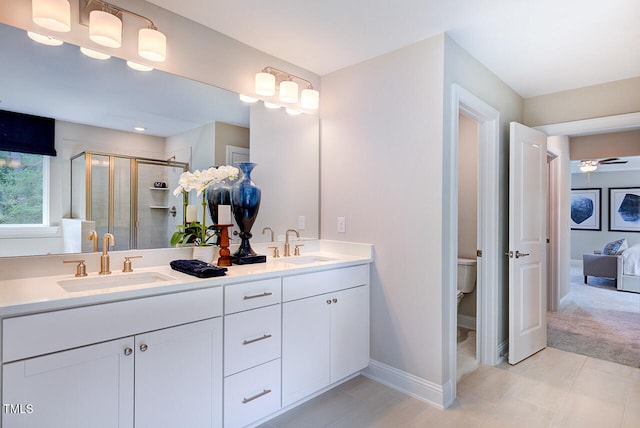 2512 Stonington Dr, Cary, NC 27523 - bathroom featuring double vanity, a shower stall, toilet, tile patterned floors, and baseboards