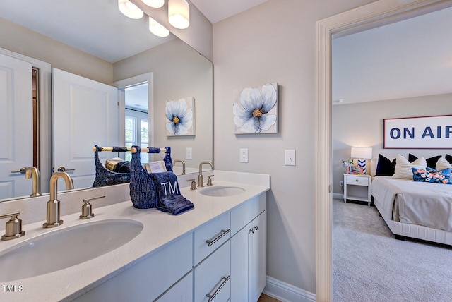 2512 Stonington Dr, Cary, NC 27523 - full bathroom with double vanity, ensuite bathroom, and baseboards