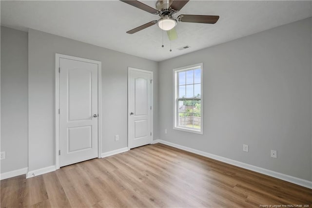 153 Abbey Ln, Raeford, NC 28376 - unfurnished bedroom featuring wood finished floors, baseboards, and ceiling fan
