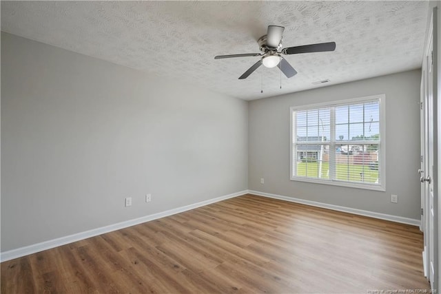 153 Abbey Ln, Raeford, NC 28376 - unfurnished room featuring wood finished floors, a textured ceiling, baseboards, and ceiling fan