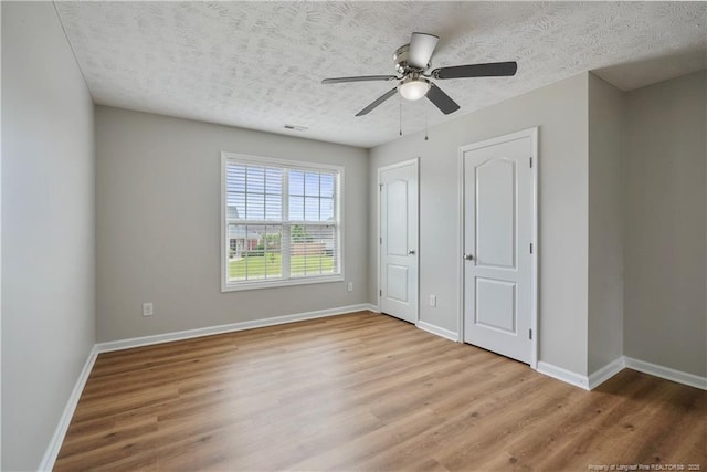 153 Abbey Ln, Raeford, NC 28376 - unfurnished bedroom featuring wood finished floors, baseboards, a textured ceiling, and ceiling fan