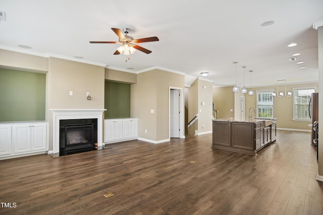 5910 Giddings St, Raleigh, NC 27616 - living room with ceiling fan, dark wood-style floors, a fireplace with flush hearth, crown molding, and baseboards