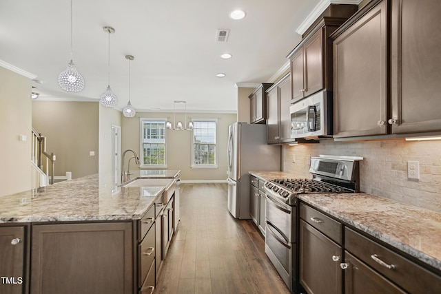 5910 Giddings St, Raleigh, NC 27616 - kitchen with appliances with stainless steel finishes, a sink, dark wood-style floors, backsplash, and ornamental molding