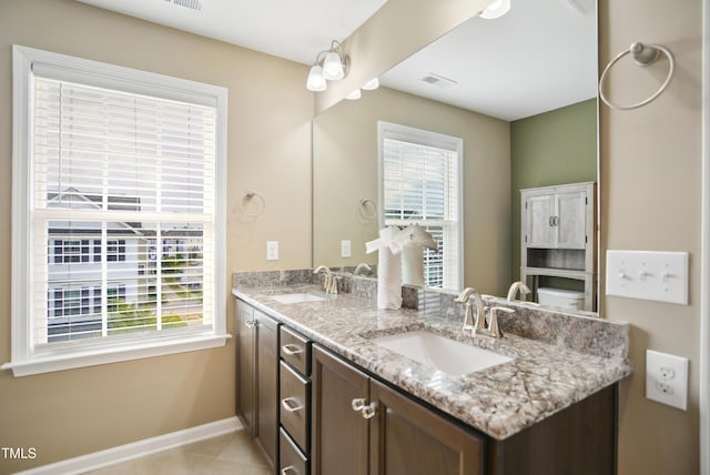 5910 Giddings St, Raleigh, NC 27616 - bathroom with double vanity, baseboards, and tile patterned flooring