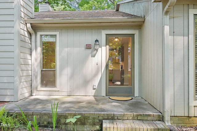 124 Twin Oaks Pl, Cary, NC 27511 - doorway to property featuring a chimney and roof with shingles
