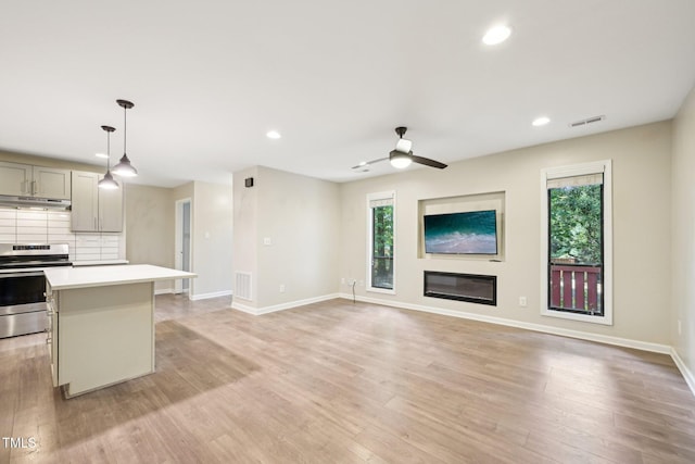 124 Twin Oaks Pl, Cary, NC 27511 - kitchen with stainless steel range with electric cooktop, a ceiling fan, light countertops, recessed lighting, and baseboards