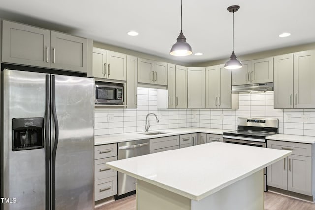 124 Twin Oaks Pl, Cary, NC 27511 - kitchen featuring stainless steel appliances, a sink, under cabinet range hood, light wood finished floors, and recessed lighting