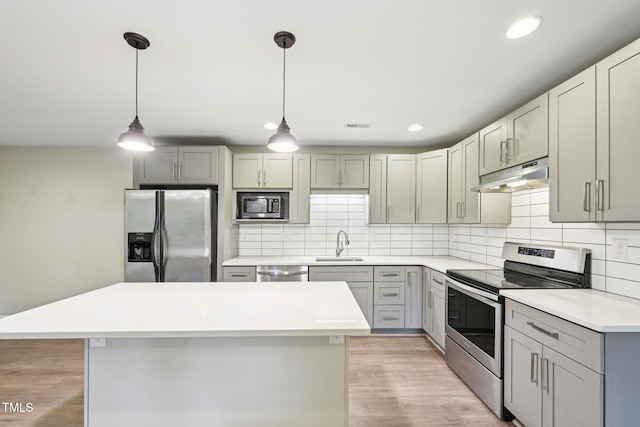 124 Twin Oaks Pl, Cary, NC 27511 - kitchen with stainless steel appliances, under cabinet range hood, a sink, gray cabinets, and backsplash