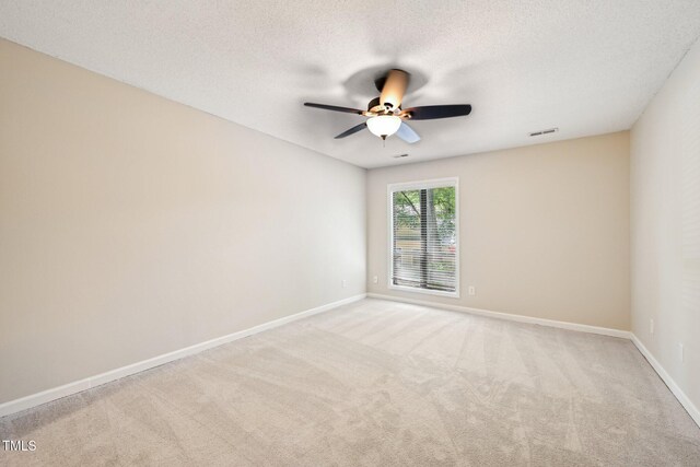 124 Twin Oaks Pl, Cary, NC 27511 - empty room featuring ceiling fan, light colored carpet, baseboards, and a textured ceiling