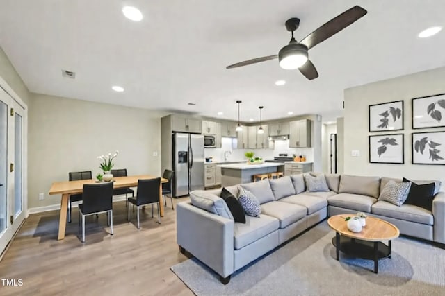 124 Twin Oaks Pl, Cary, NC 27511 - living room featuring recessed lighting, light wood-style flooring, a ceiling fan, and baseboards