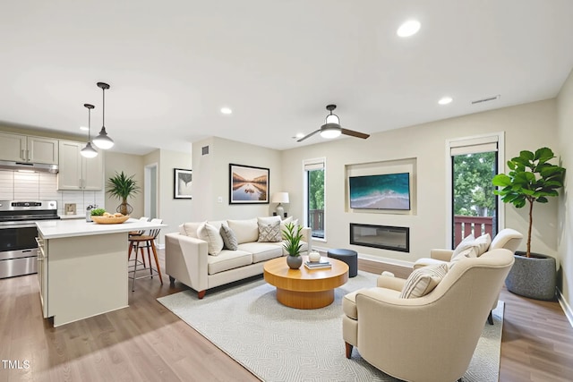 124 Twin Oaks Pl, Cary, NC 27511 - living room with healthy amount of natural light, recessed lighting, light wood-style floors, ceiling fan, and baseboards