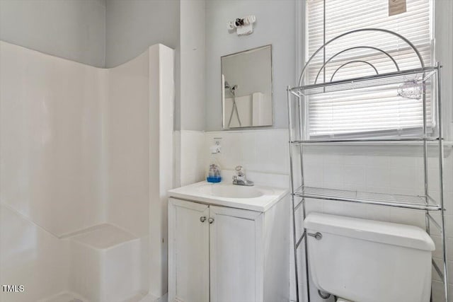 4412 Green Spring Dr, Garner, NC 27529 - bathroom with tile walls, vanity, and a shower