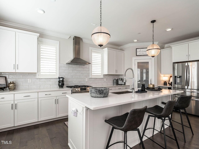 1610 Draper View Loop Unit 101, Raleigh, NC 27608 - kitchen featuring wall chimney range hood, stainless steel appliances, ornamental molding, white cabinets, and light countertops