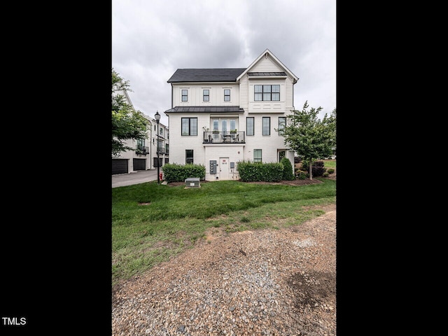 1610 Draper View Loop Unit 101, Raleigh, NC 27608 - view of front facade with a standing seam roof, a metal roof, a balcony, and a front yard