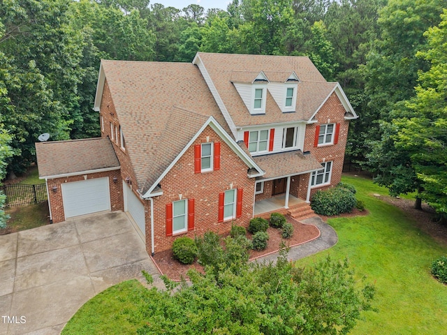 1124 Kalworth Rd, Wake Forest, NC 27587 - view of front of property with concrete driveway, brick siding, an attached garage, roof with shingles, and covered porch