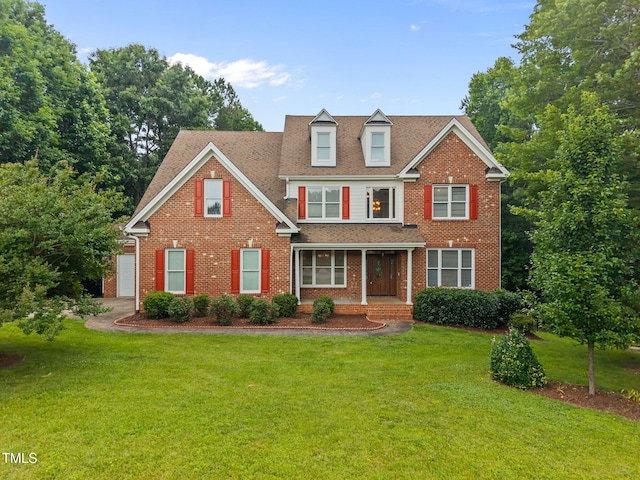 1124 Kalworth Rd, Wake Forest, NC 27587 - view of front facade featuring a front yard, covered porch, brick siding, and a garage