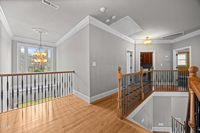 1124 Kalworth Rd, Wake Forest, NC 27587 - hallway with an upstairs landing, attic access, healthy amount of natural light, wood finished floors, and ornamental molding