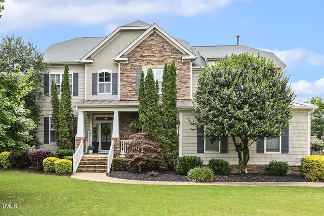5516 Colonial Oaks Dr, Apex, NC 27539 - craftsman-style home featuring a front yard, covered porch, a standing seam roof, and metal roof