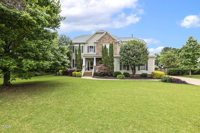 5516 Colonial Oaks Dr, Apex, NC 27539 - view of front facade with a standing seam roof, a front lawn, metal roof, and stone siding