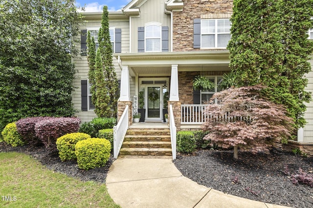 5516 Colonial Oaks Dr, Apex, NC 27539 - view of exterior entry with stone siding and covered porch
