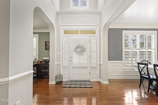 5516 Colonial Oaks Dr, Apex, NC 27539 - foyer entrance featuring arched walkways, wood finished floors, and ornamental molding