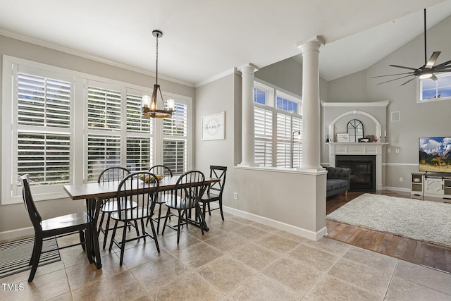 5516 Colonial Oaks Dr, Apex, NC 27539 - tiled dining area with baseboards, a glass covered fireplace, a ceiling fan, ornamental molding, and decorative columns
