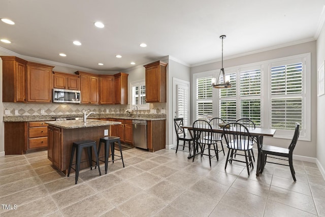 5516 Colonial Oaks Dr, Apex, NC 27539 - kitchen featuring appliances with stainless steel finishes, ornamental molding, brown cabinets, backsplash, and baseboards