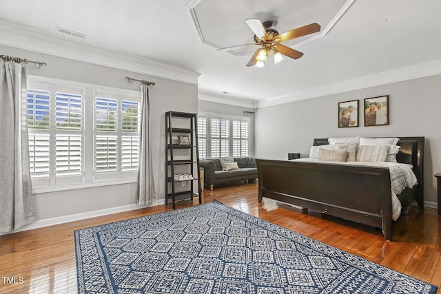 5516 Colonial Oaks Dr, Apex, NC 27539 - bedroom featuring multiple windows, wood-type flooring, crown molding, and baseboards