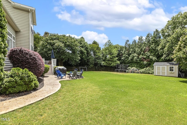 5516 Colonial Oaks Dr, Apex, NC 27539 - view of yard with a trampoline, a patio area, and an outdoor fire pit