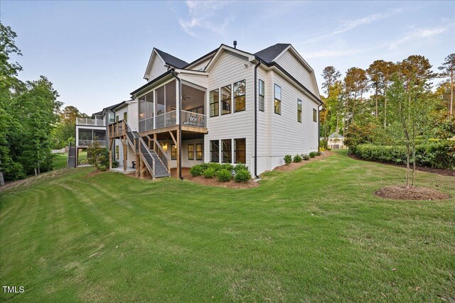 111 Stone Park Dr, Wake Forest, NC 27587 - rear view of house with a sunroom, a yard, a wooden deck, and stairs