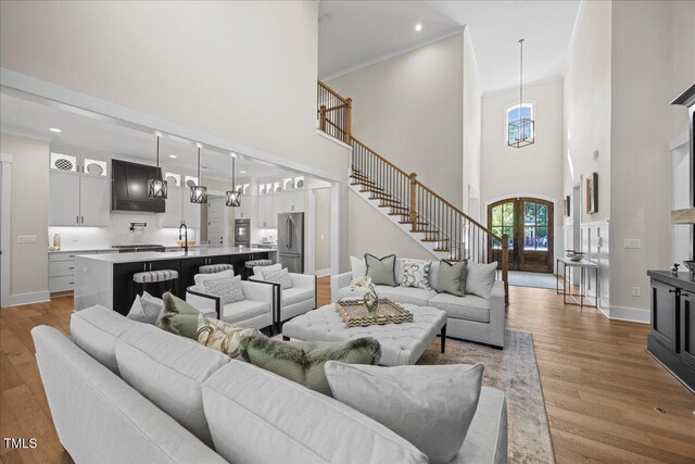 111 Stone Park Dr, Wake Forest, NC 27587 - living room featuring a high ceiling, wood finished floors, baseboards, recessed lighting, and french doors