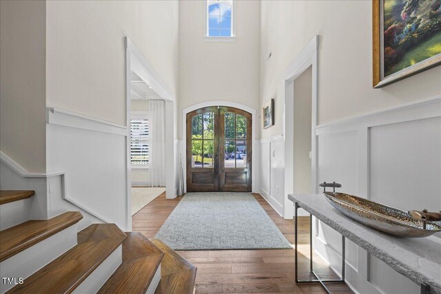 111 Stone Park Dr, Wake Forest, NC 27587 - entrance foyer with wainscoting, plenty of natural light, wood finished floors, a high ceiling, and a decorative wall