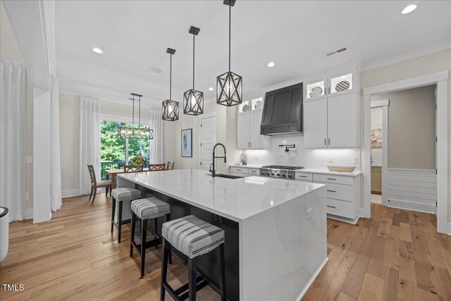 111 Stone Park Dr, Wake Forest, NC 27587 - kitchen featuring a sink, premium range hood, a large island, light wood-type flooring, and backsplash