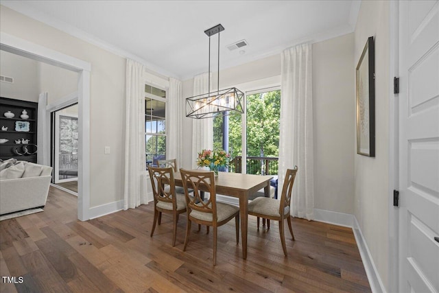 111 Stone Park Dr, Wake Forest, NC 27587 - dining space featuring dark wood finished floors, a chandelier, baseboards, and ornamental molding
