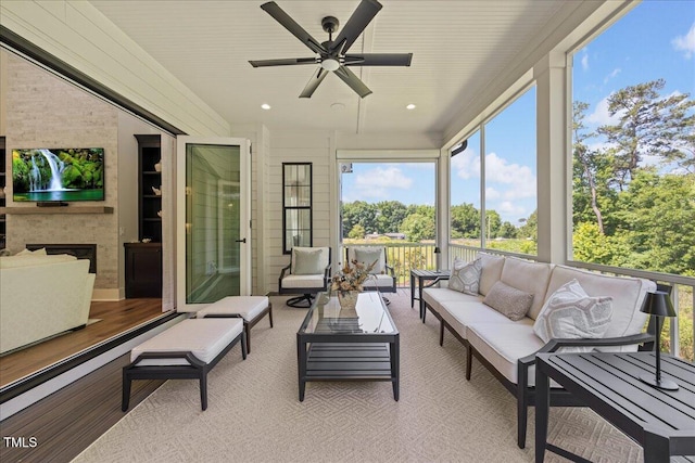 111 Stone Park Dr, Wake Forest, NC 27587 - sunroom featuring an outdoor living space with a fireplace, a ceiling fan, and plenty of natural light