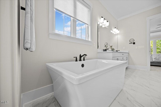 111 Stone Park Dr, Wake Forest, NC 27587 - bathroom with marble finish floors, vanity, a freestanding bath, crown molding, and baseboards