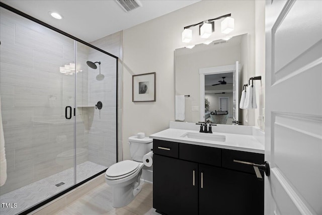 111 Stone Park Dr, Wake Forest, NC 27587 - bathroom with vanity, toilet, a shower stall, a ceiling fan, and recessed lighting