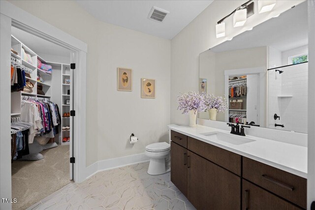 111 Stone Park Dr, Wake Forest, NC 27587 - bathroom featuring a spacious closet, vanity, toilet, baseboards, and a shower