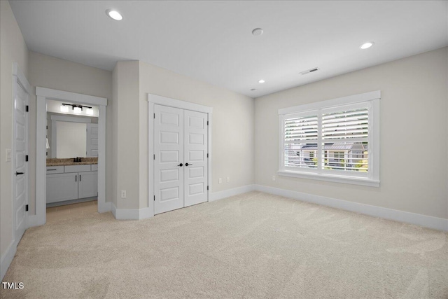 111 Stone Park Dr, Wake Forest, NC 27587 - unfurnished bedroom featuring light carpet, baseboards, recessed lighting, a sink, and a closet