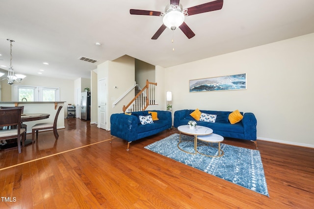 1017 Frank Page Dr, Cary, NC 27511 - living area with stairway, wood finished floors, a chandelier, ceiling fan, and baseboards